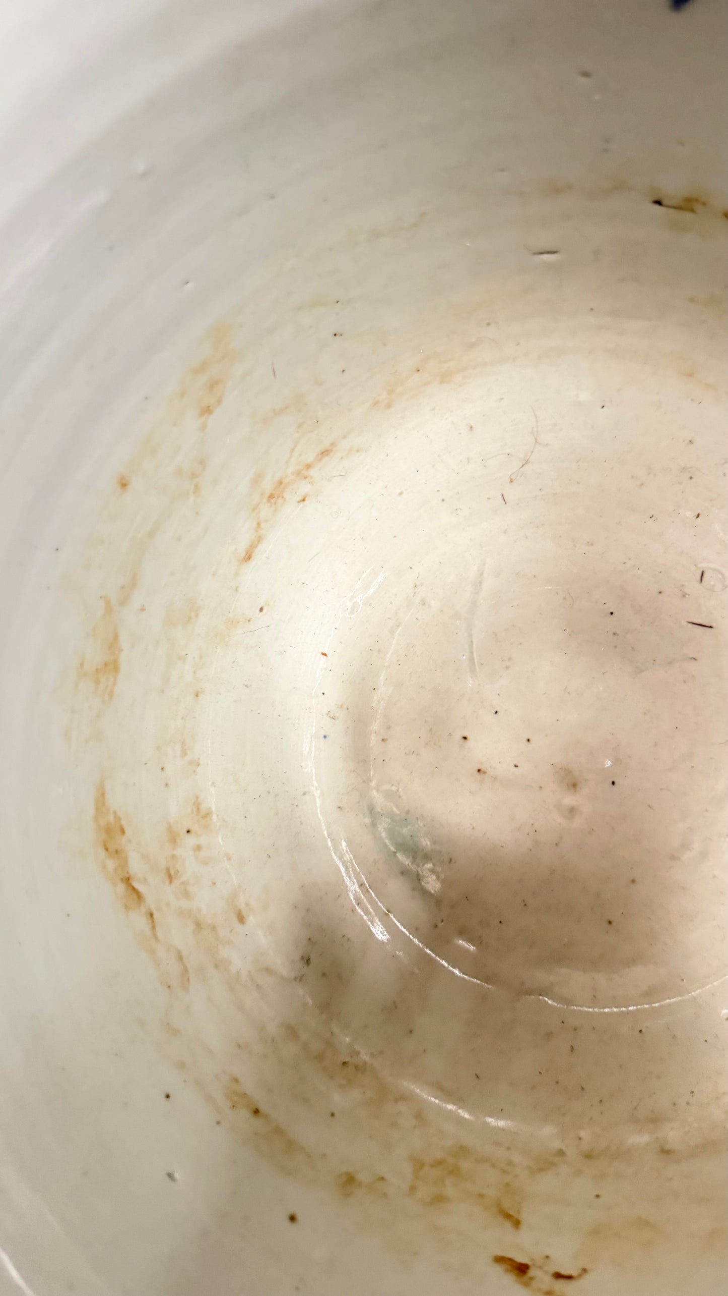 Interior base staining and age-related wear in the antique Japanese porcelain jardinière.