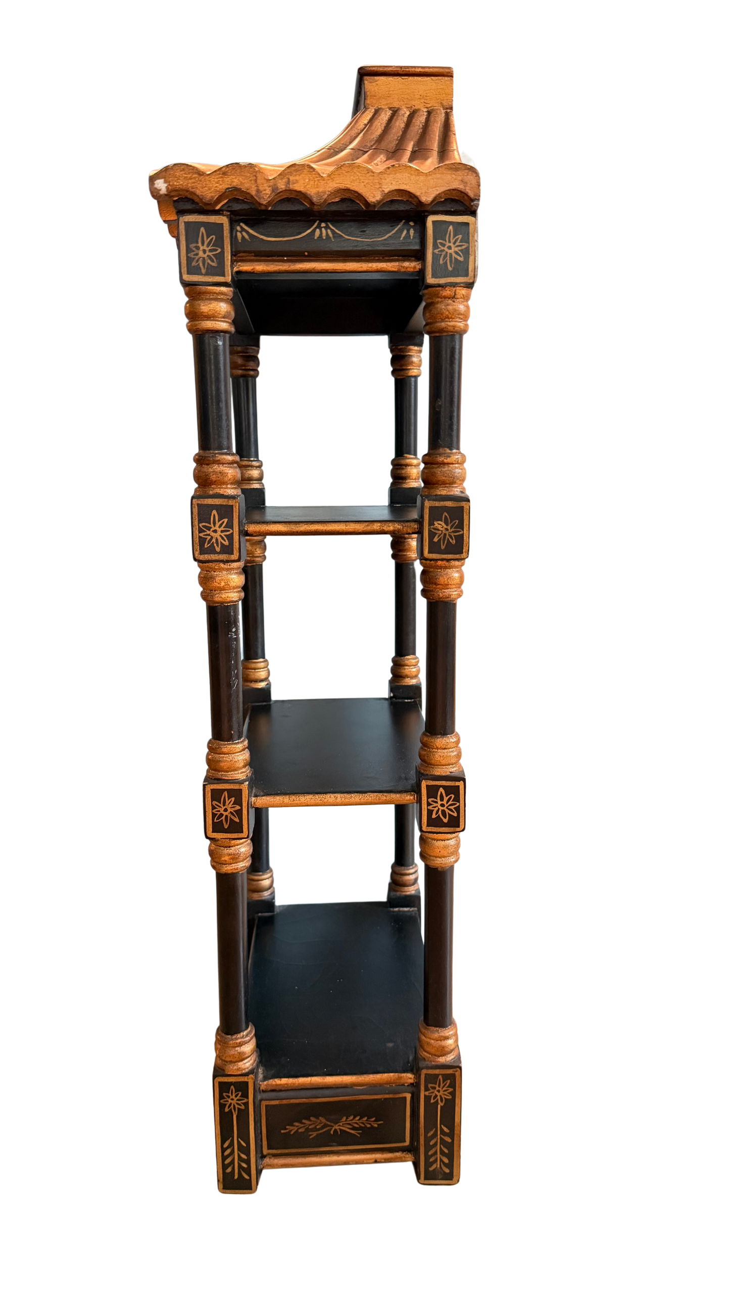 Left-side view of vintage black and gold chinoiserie pagoda wall shelf with three tiers and scalloped roof.