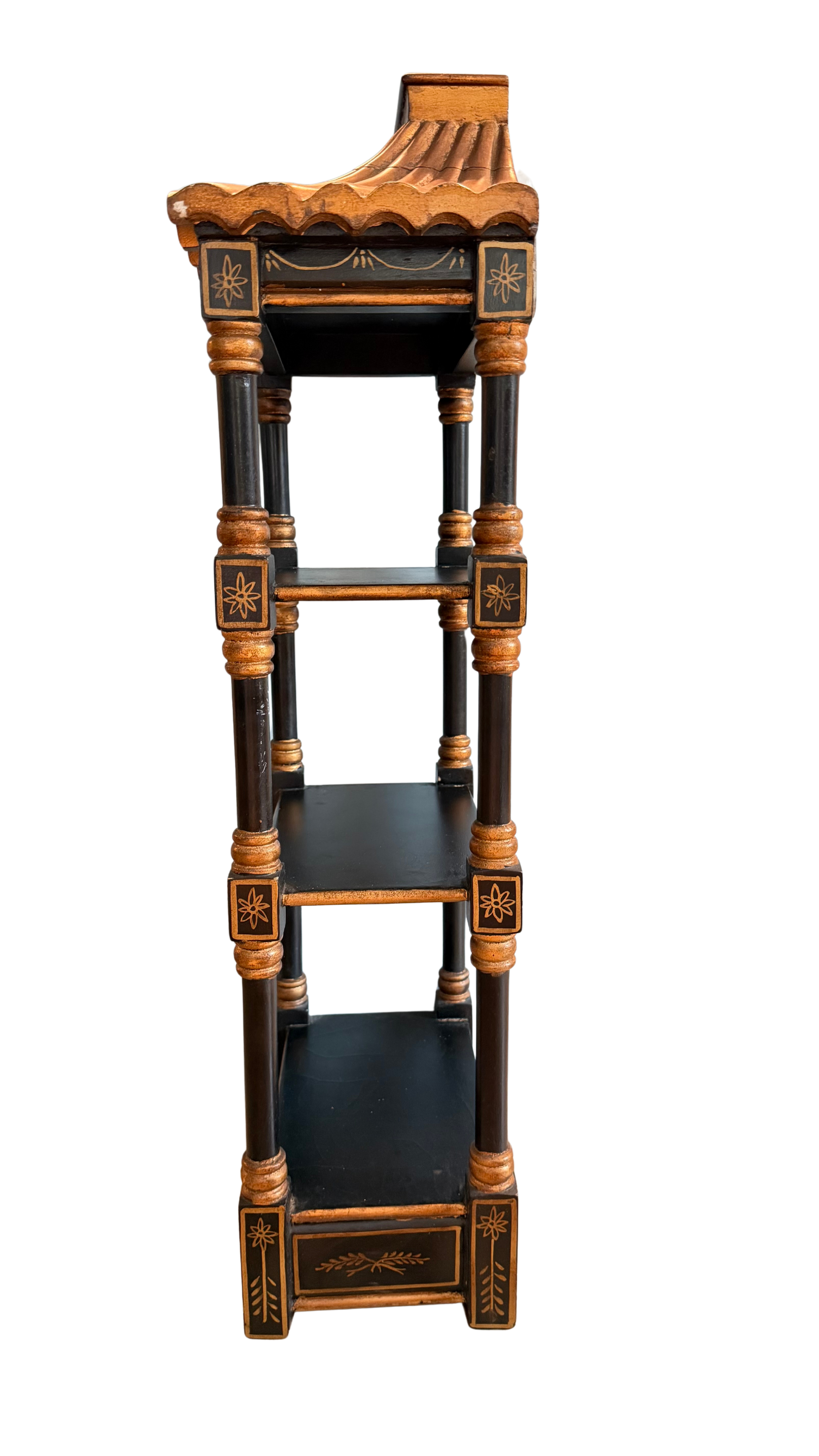 Left-side view of vintage black and gold chinoiserie pagoda wall shelf with three tiers and scalloped roof.