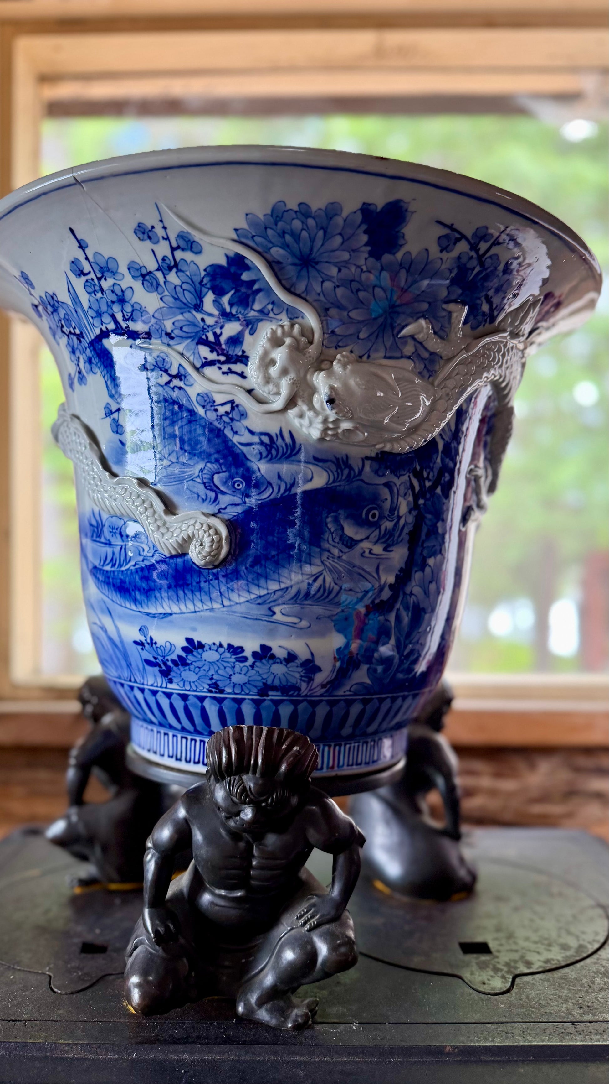 Close-up of the raised white dragon on an antique Japanese blue-and-white jardinière.