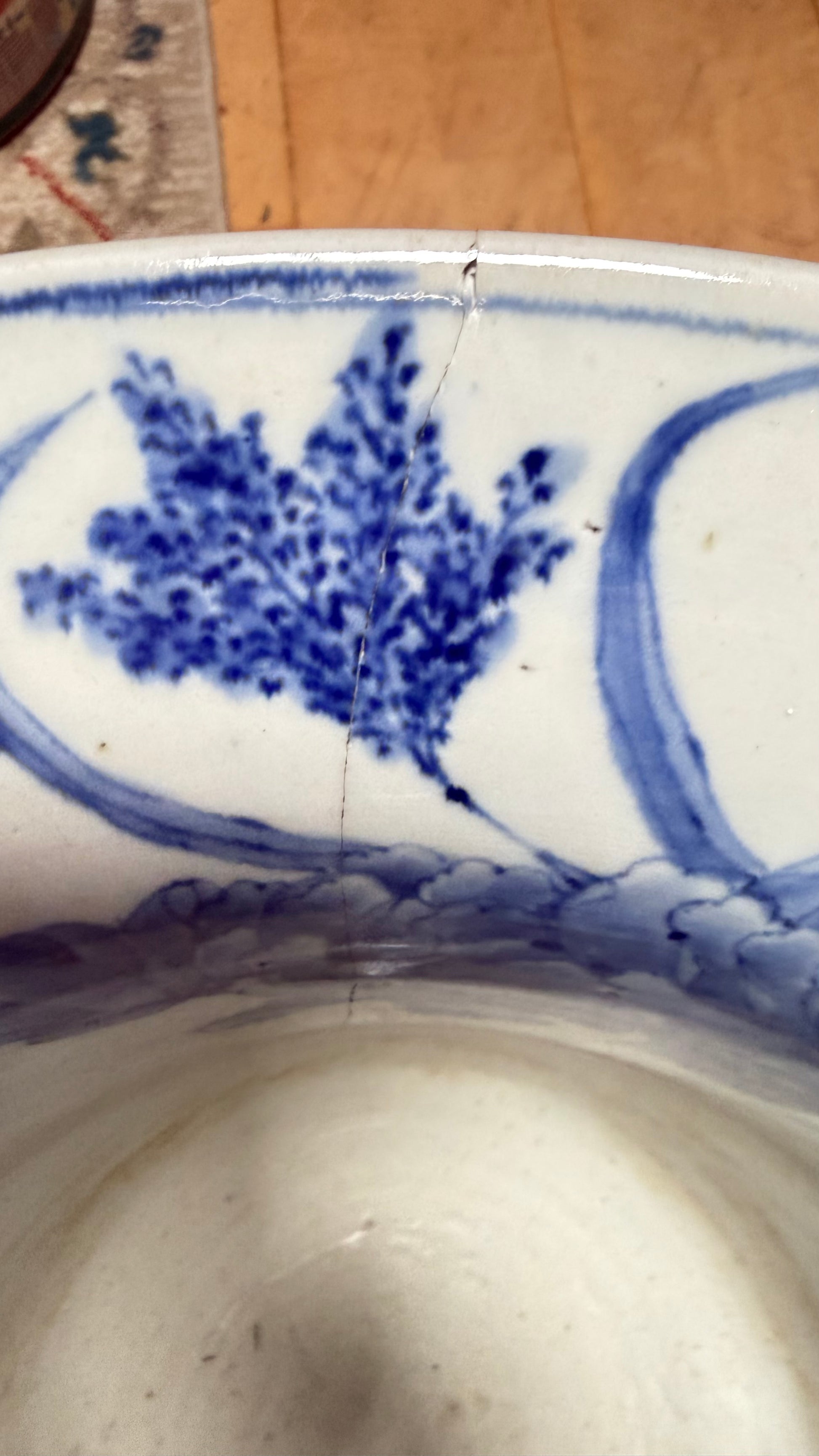 Interior view of a rim chip and hairline on the antique Japanese jardinière.