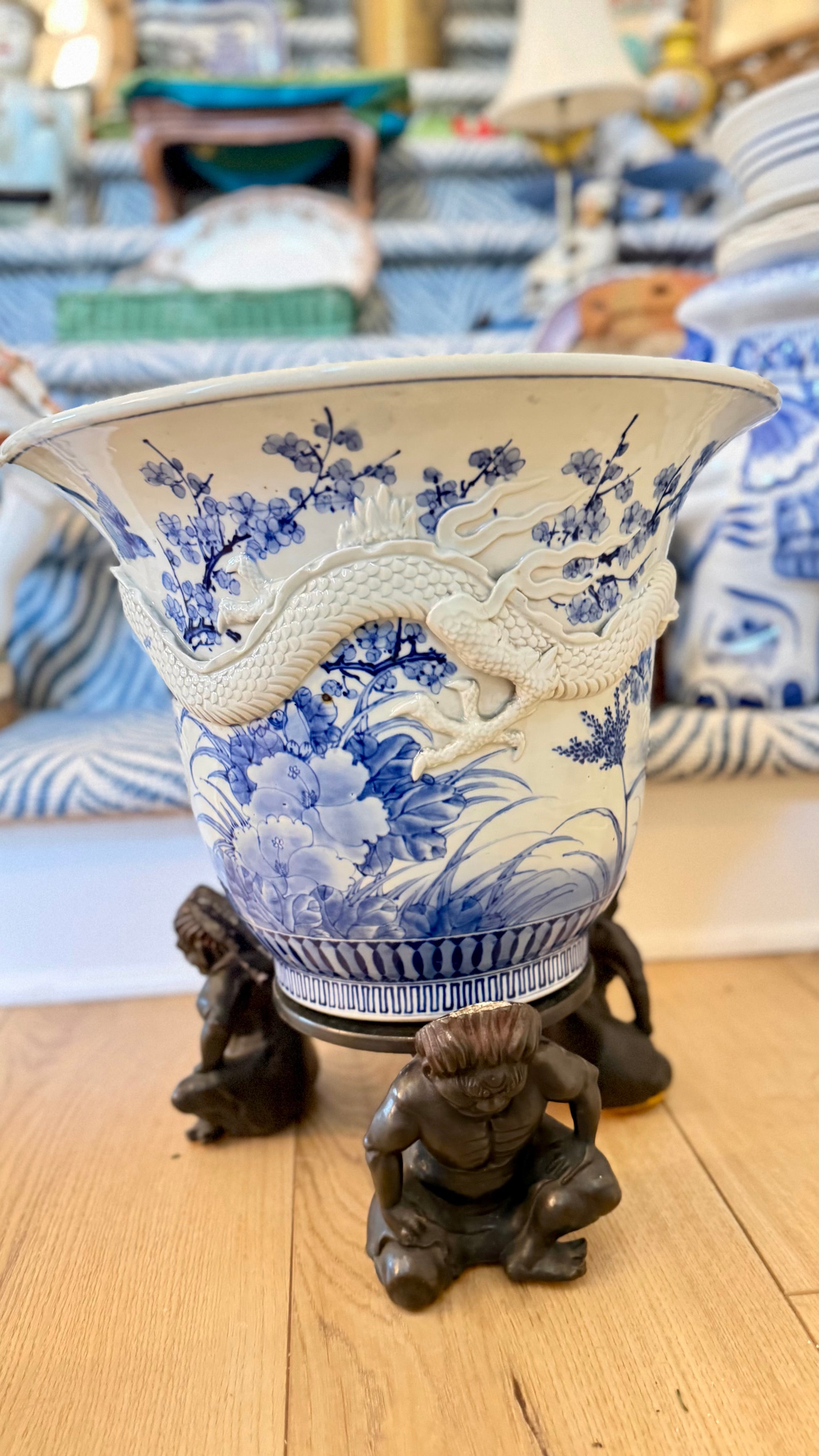 Japanese dragon jardinière styled with blue-and-white porcelain in a collected interior.