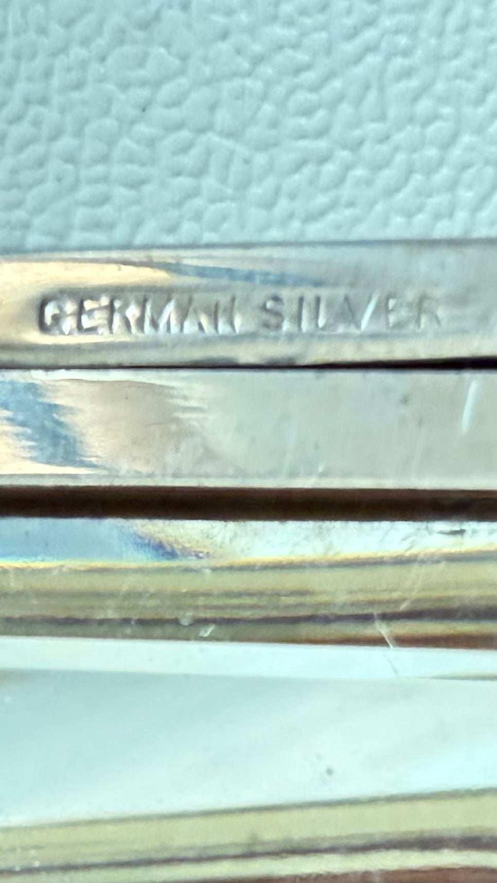 Close-up of “German Silver” stamp on the interior frame of an antique dance purse.