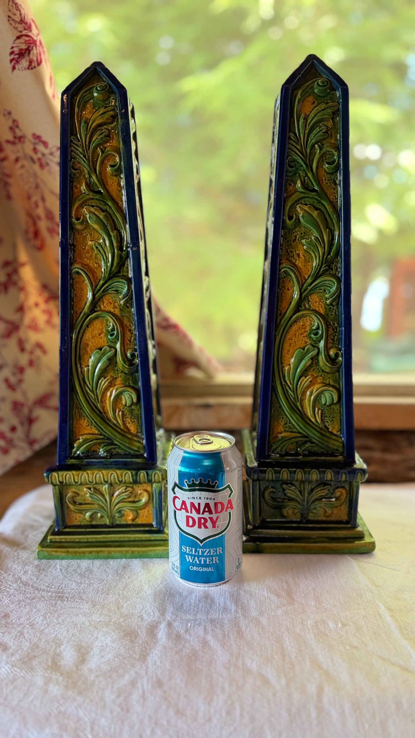 Pair of vintage Italian terracotta obelisks shown beside a beverage can for scale.