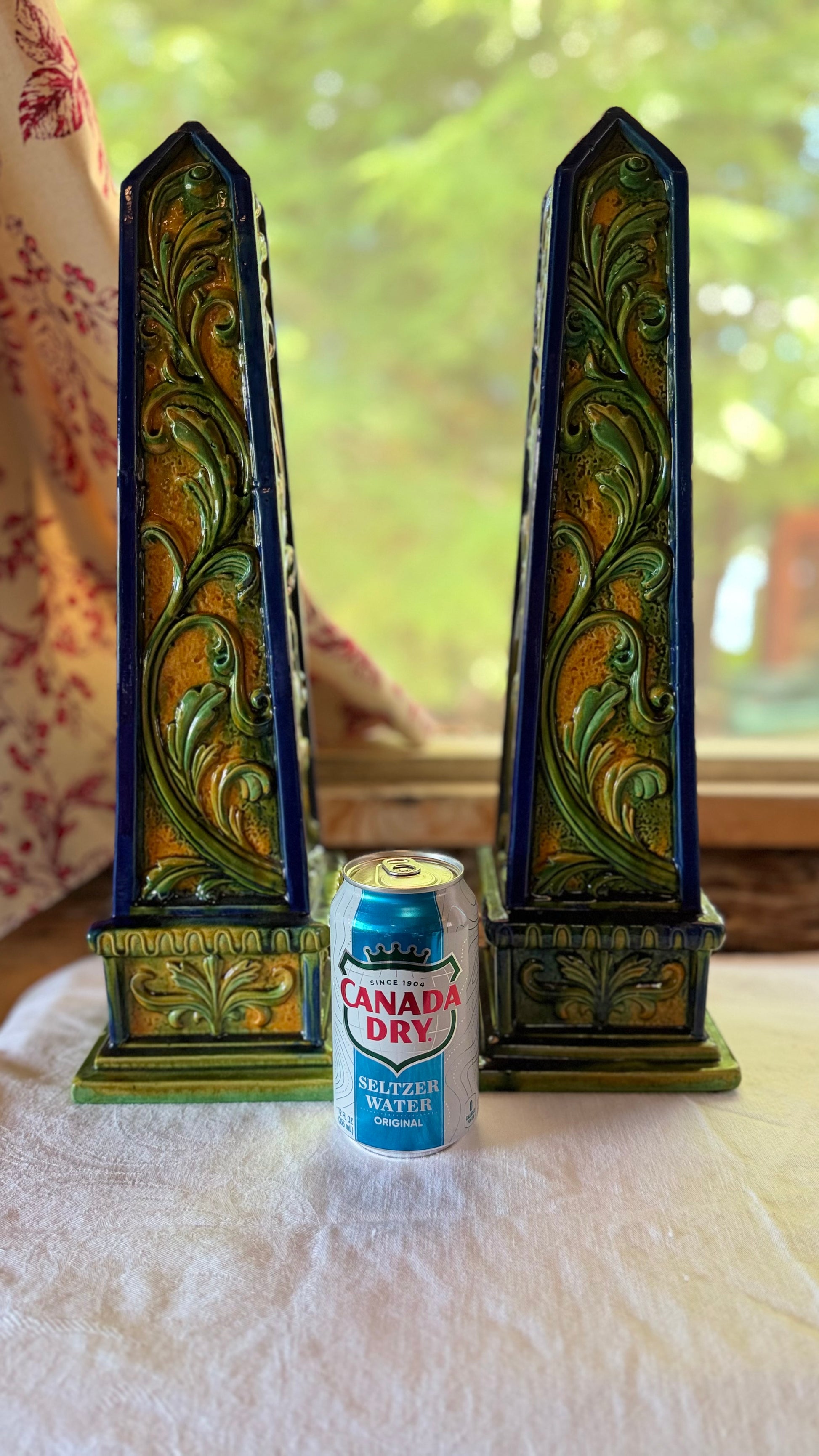 Pair of vintage Italian terracotta obelisks shown beside a beverage can for scale.