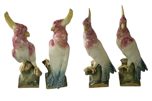 Pair of antique Royal Dux Bohemia cockatoo figurines shown from front and side angles.