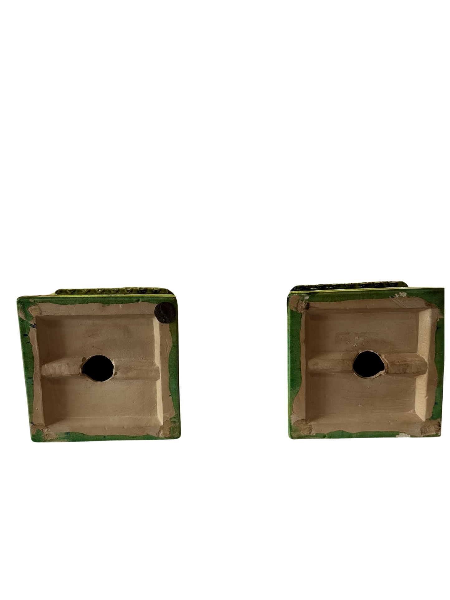 Undersides of two vintage Italian terracotta obelisks with recessed bases and central openings.